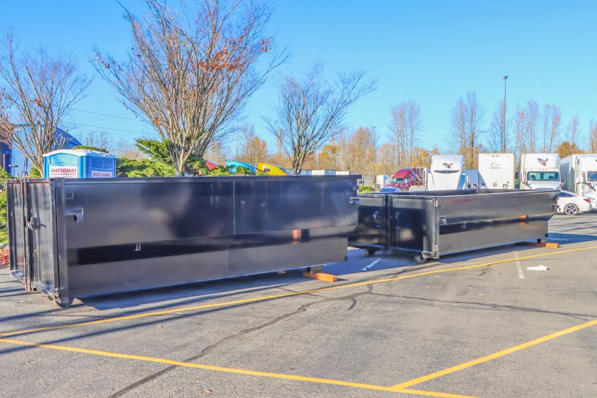 Professional dumpster rental service with roll-off container on residential driveway in Waveland